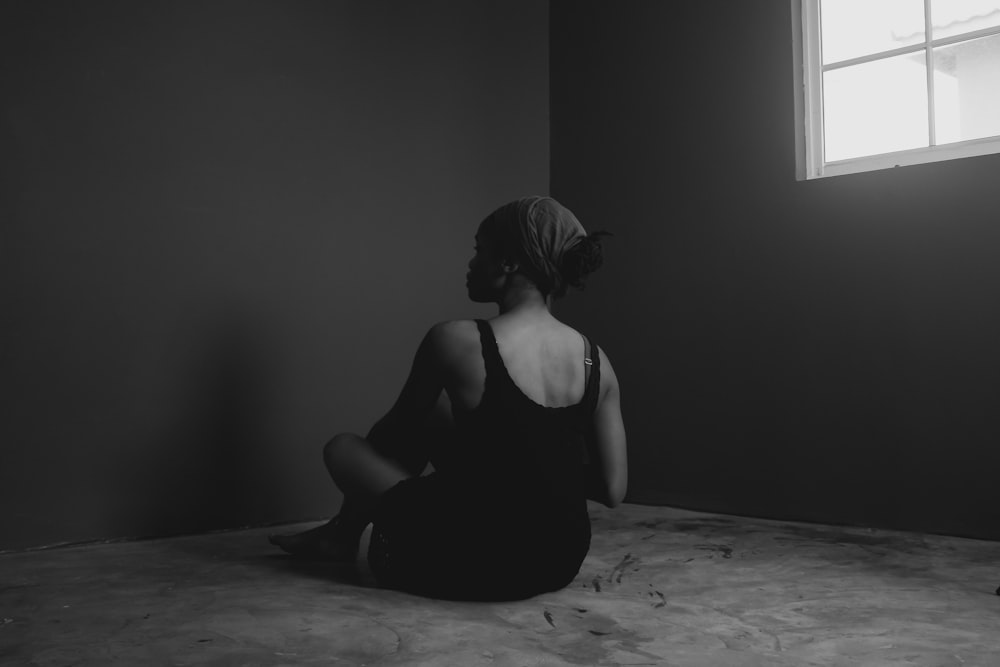 woman in black tank top sitting on floor