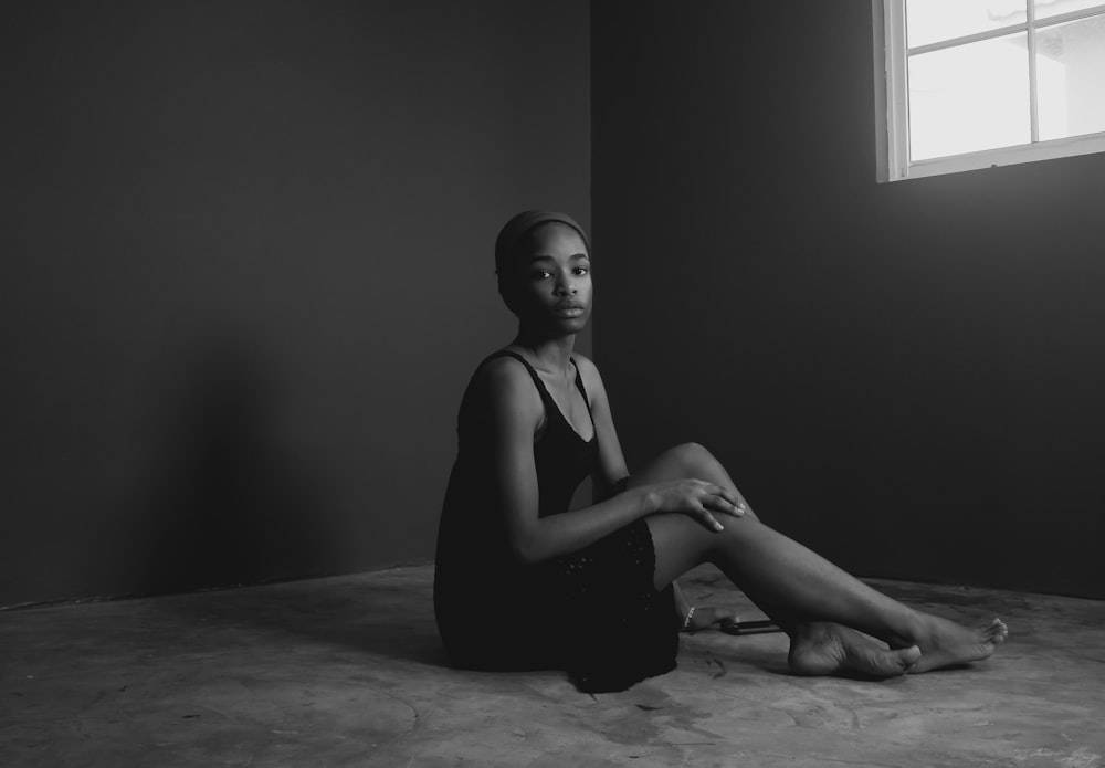 woman in black tank top sitting on floor