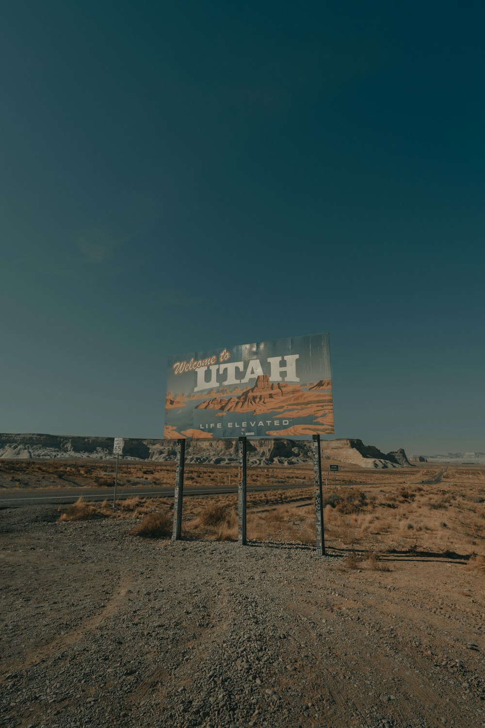 a sign in the middle of a dirt road