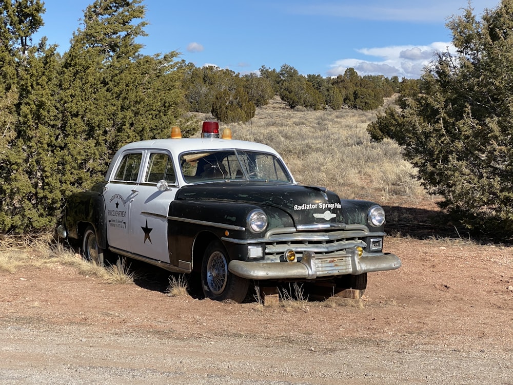 black and white vintage car on brown field during daytime