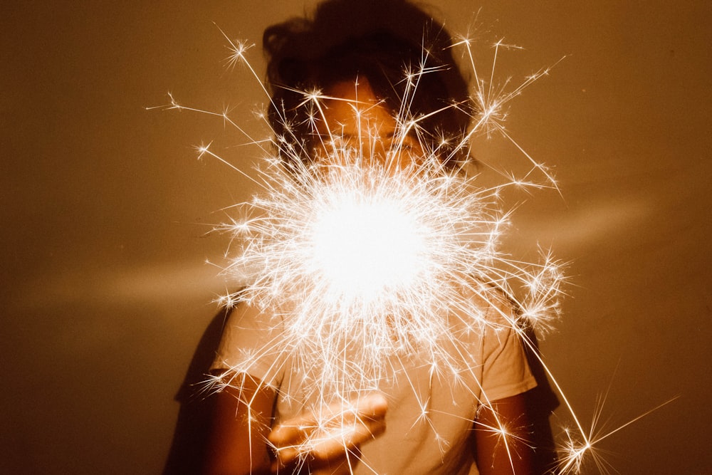 person holding white dandelion flower