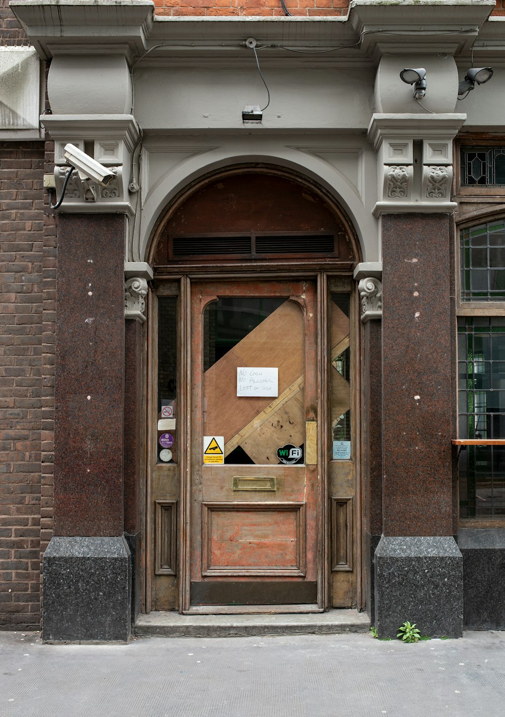 brown wooden door on brown brick building