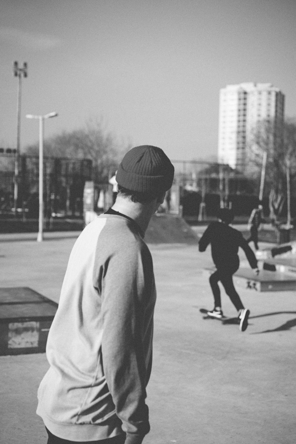 man in white shirt and black shorts playing basketball in grayscale photography