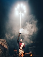 man in red and white jacket holding white and red flag