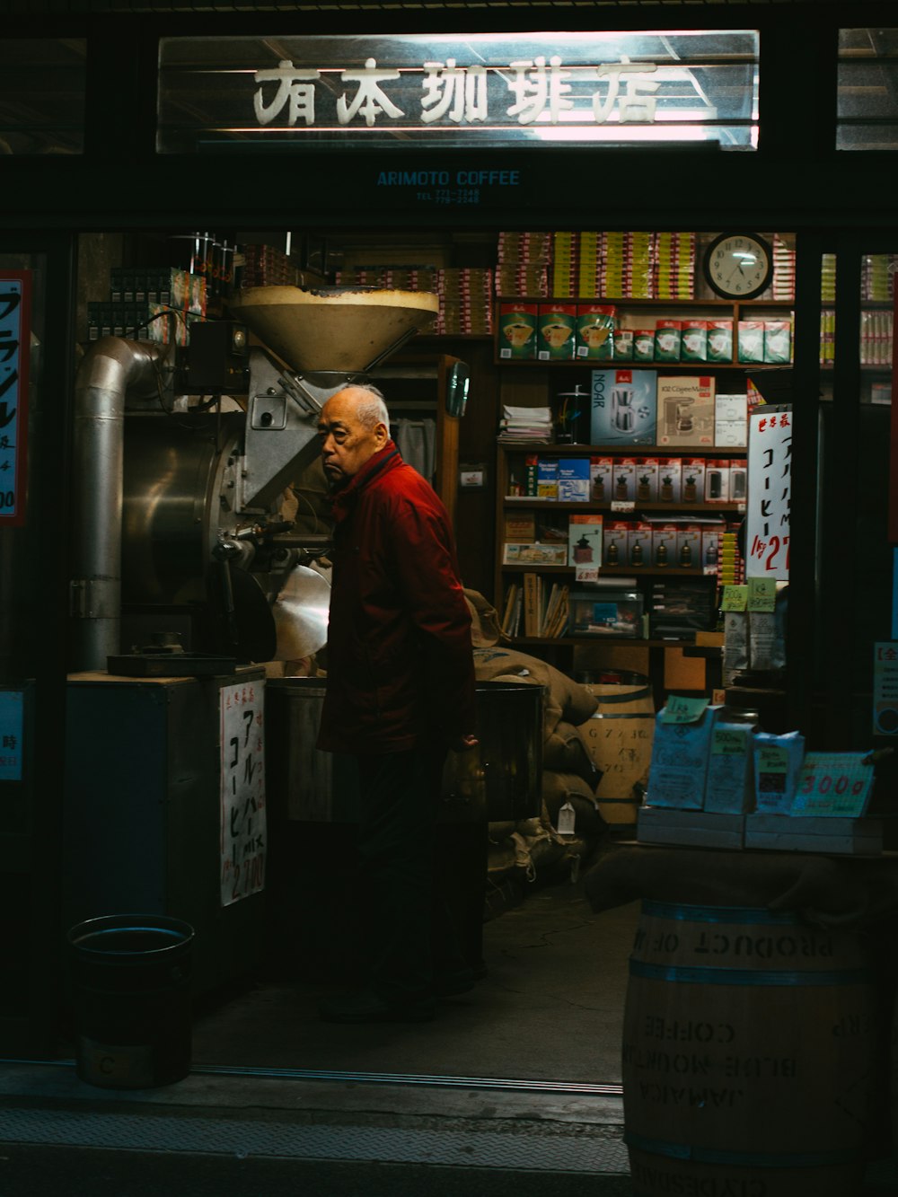 man in brown jacket standing near black and gray vending machine