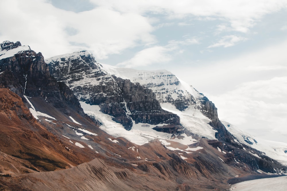 snow covered mountain under cloudy sky during daytime