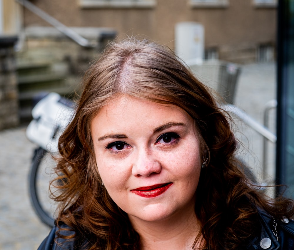 woman in blue shirt with red lipstick