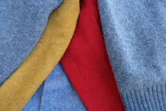 A close-up shot of vibrant textile fabrics layered to show texture and color depth.