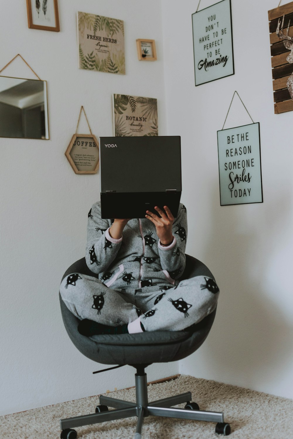 person in gray and black hoodie using black tablet computer