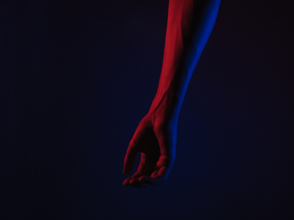 persons hand with blue and red color