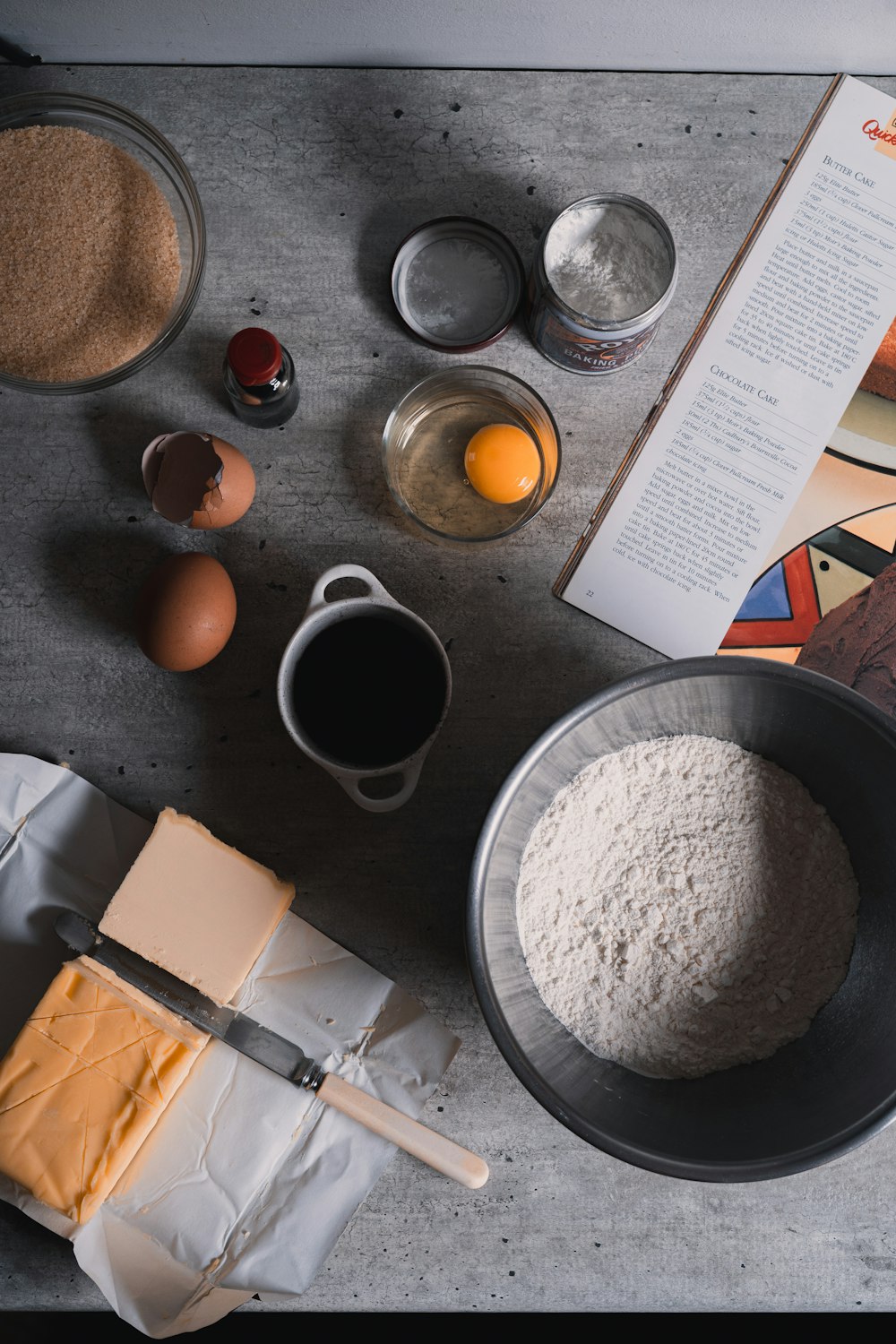 white ceramic mug beside brown paper