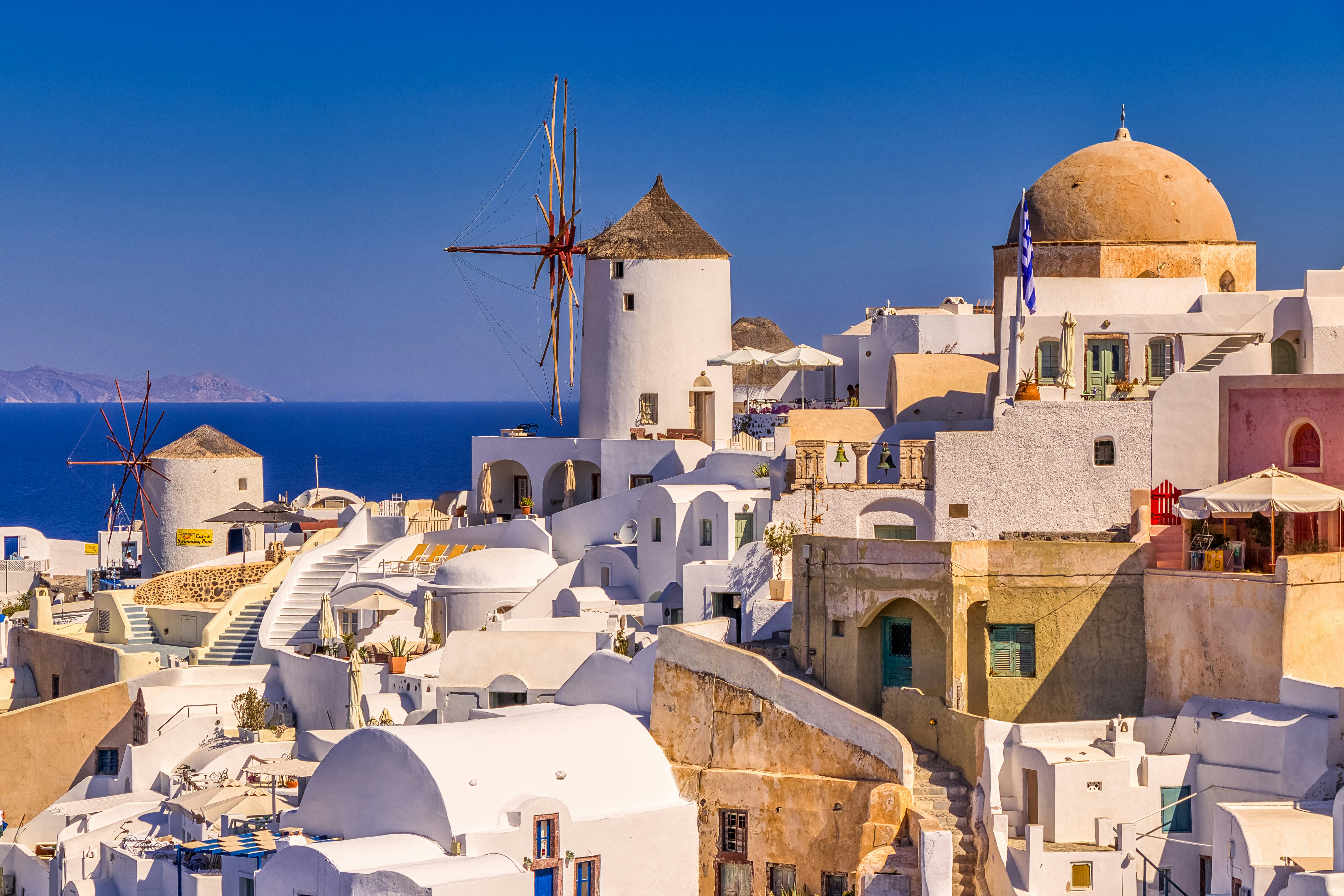 white and brown concrete houses near body of water during daytime, Santorini