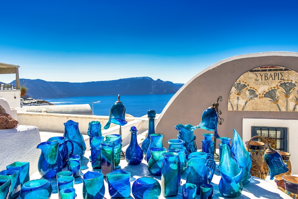 blue glass bottles on blue glass table