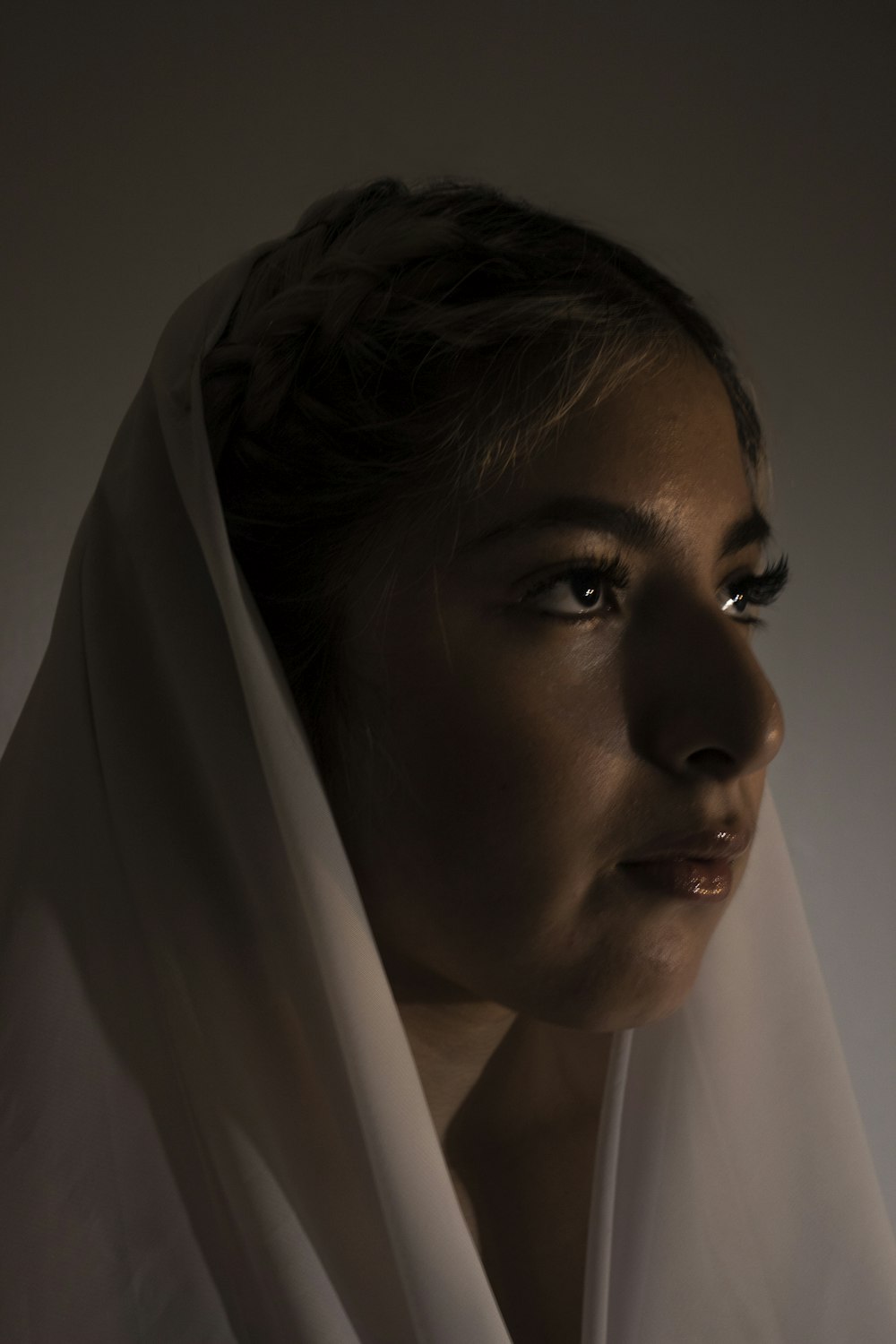 woman in white hijab near white curtain