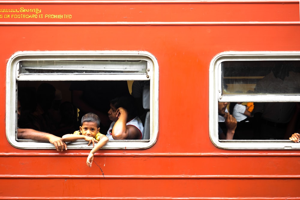 2 men sitting on red train