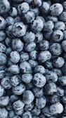 black round fruits on white surface