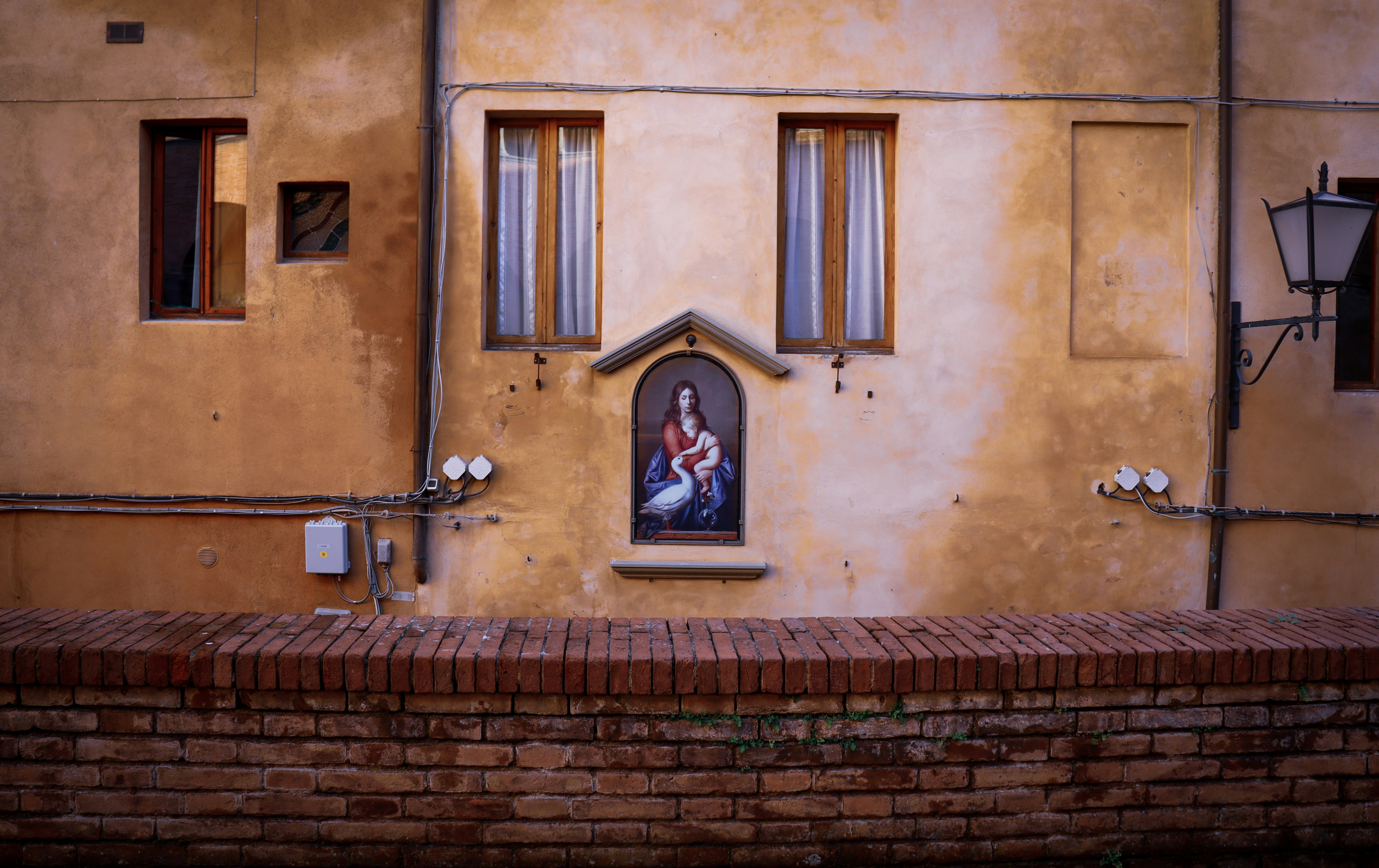 brown brick building with black metal door lever