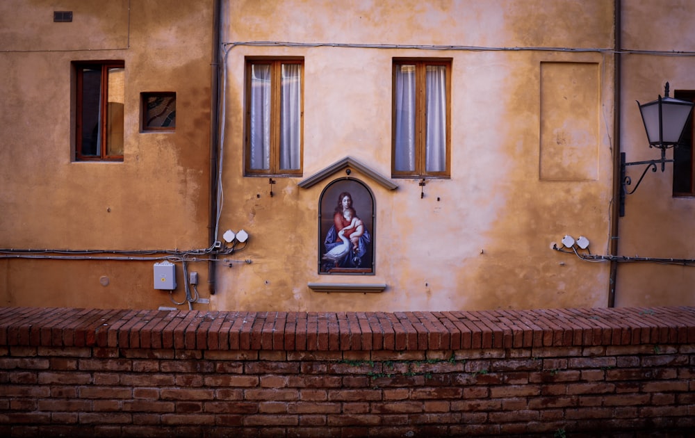 brown brick building with black metal door lever