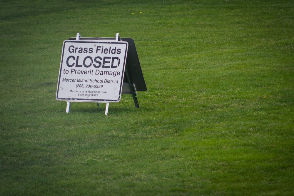 white and black signage on green grass field
