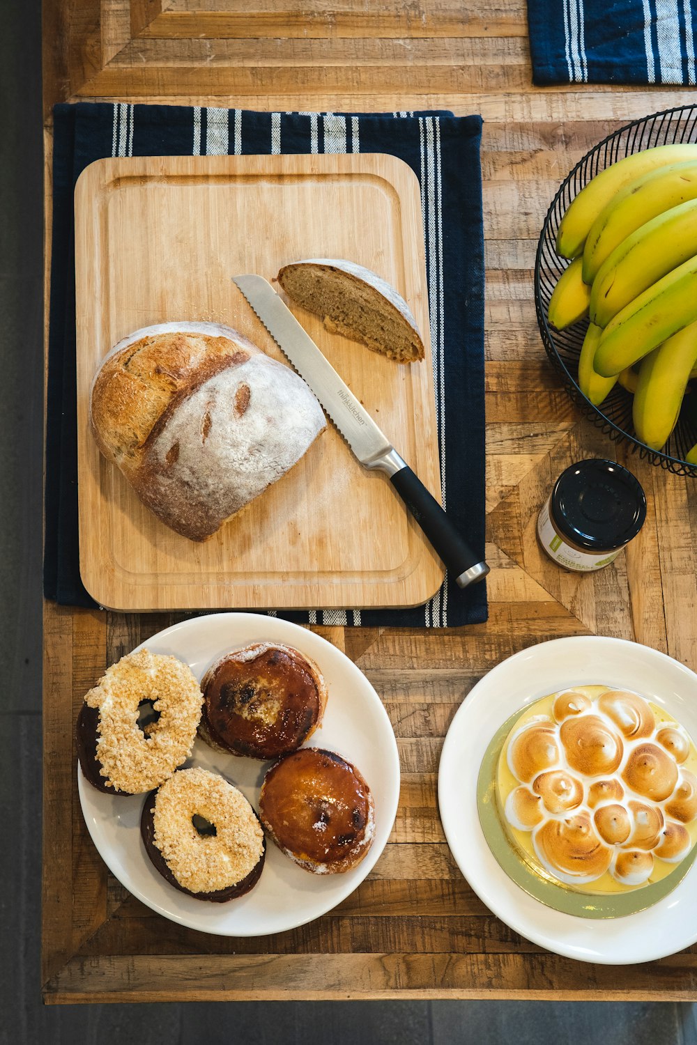 sliced bread on white ceramic plate beside sliced banana on brown wooden chopping board