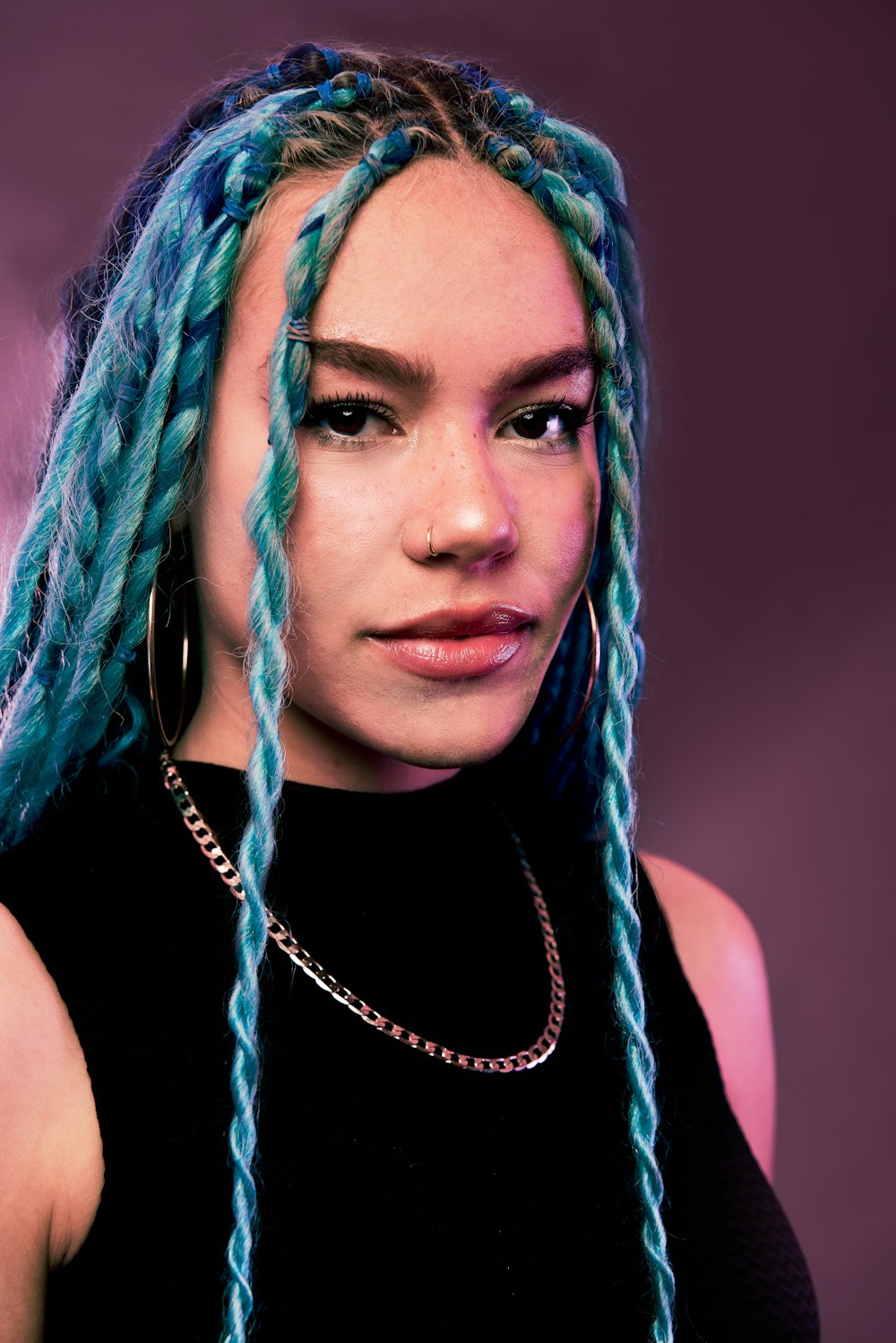 woman with blue hair wearing black tank top