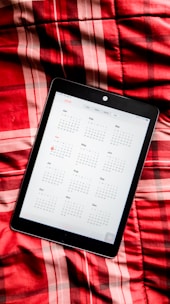 Close-up of a calendar app on a tablet with booked appointments highlighted.