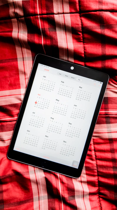 A sleek digital tablet displaying the 2026 Life Command Center planner interface with navy blue and gold accents.
