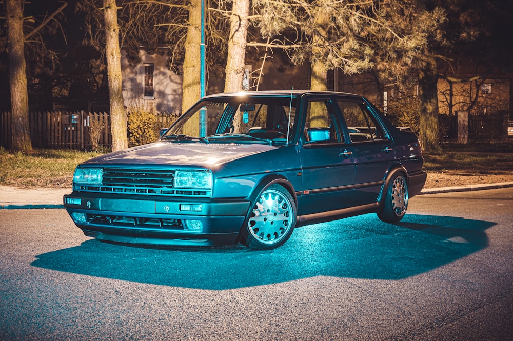 blue car parked on the side of the road