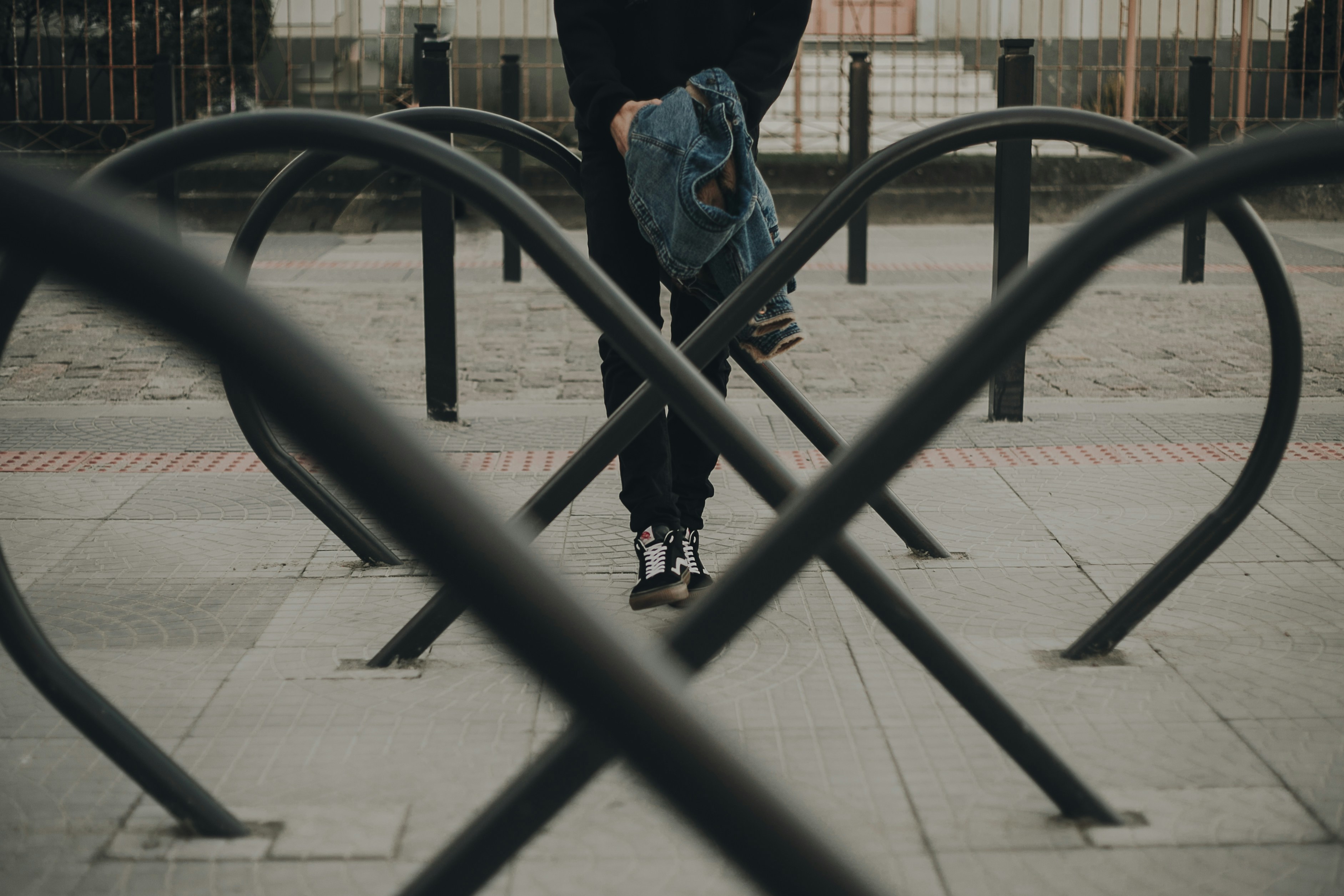 Person in blue denim jeans standing on sidewalk during daytime photo ...