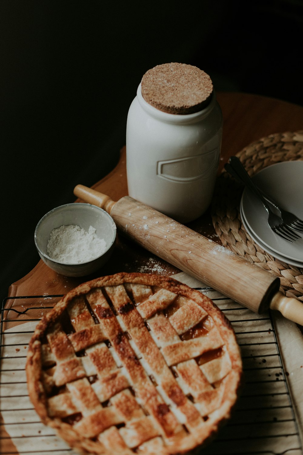 white ceramic mug beside brown wooden rolling pin