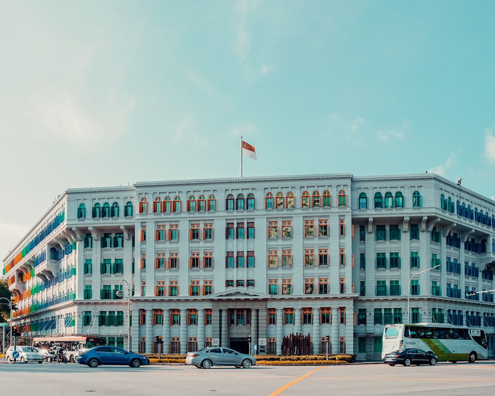 cars parked in front of brown concrete building during daytime