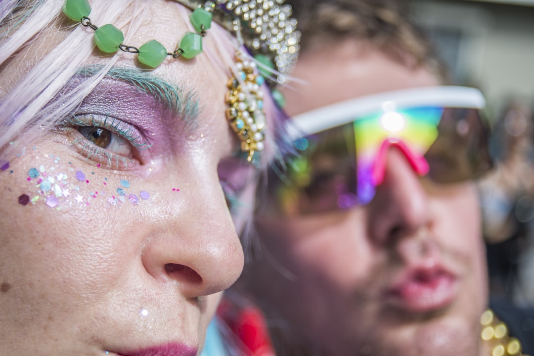 woman wearing blue framed sunglasses, Mardi Gras Queen + constituent