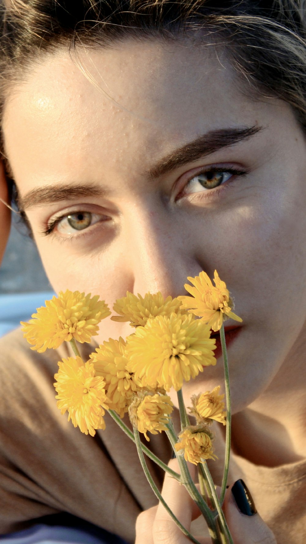 woman holding yellow flower during daytime