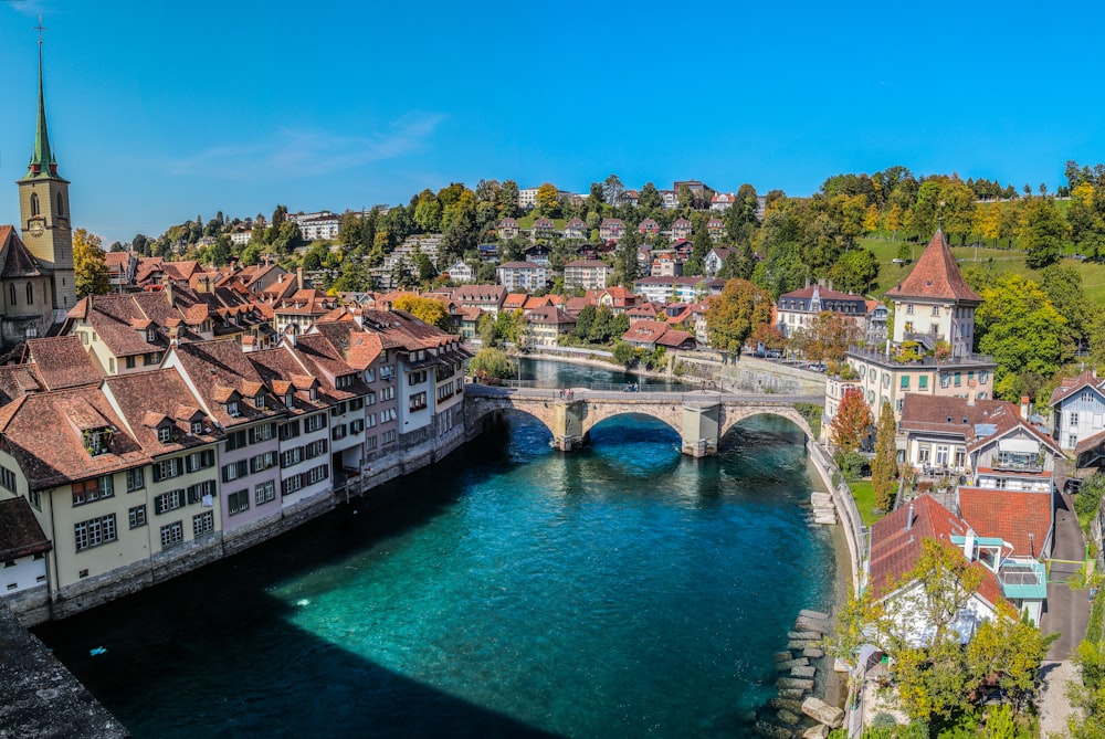 white and brown concrete bridge over blue body of water during daytime