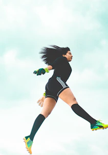 Dynamic athlete mid-action with sleek neon blue lighting highlighting movement.
