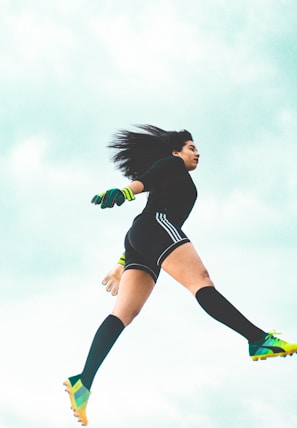 An action shot of an athlete wearing full Shieldsport gear mid-motion on a sports field.