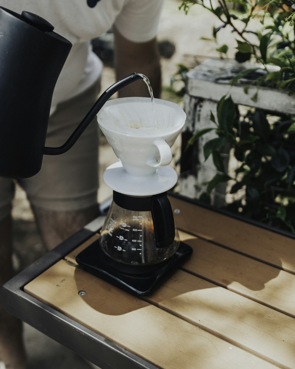 black coffee press on brown wooden table