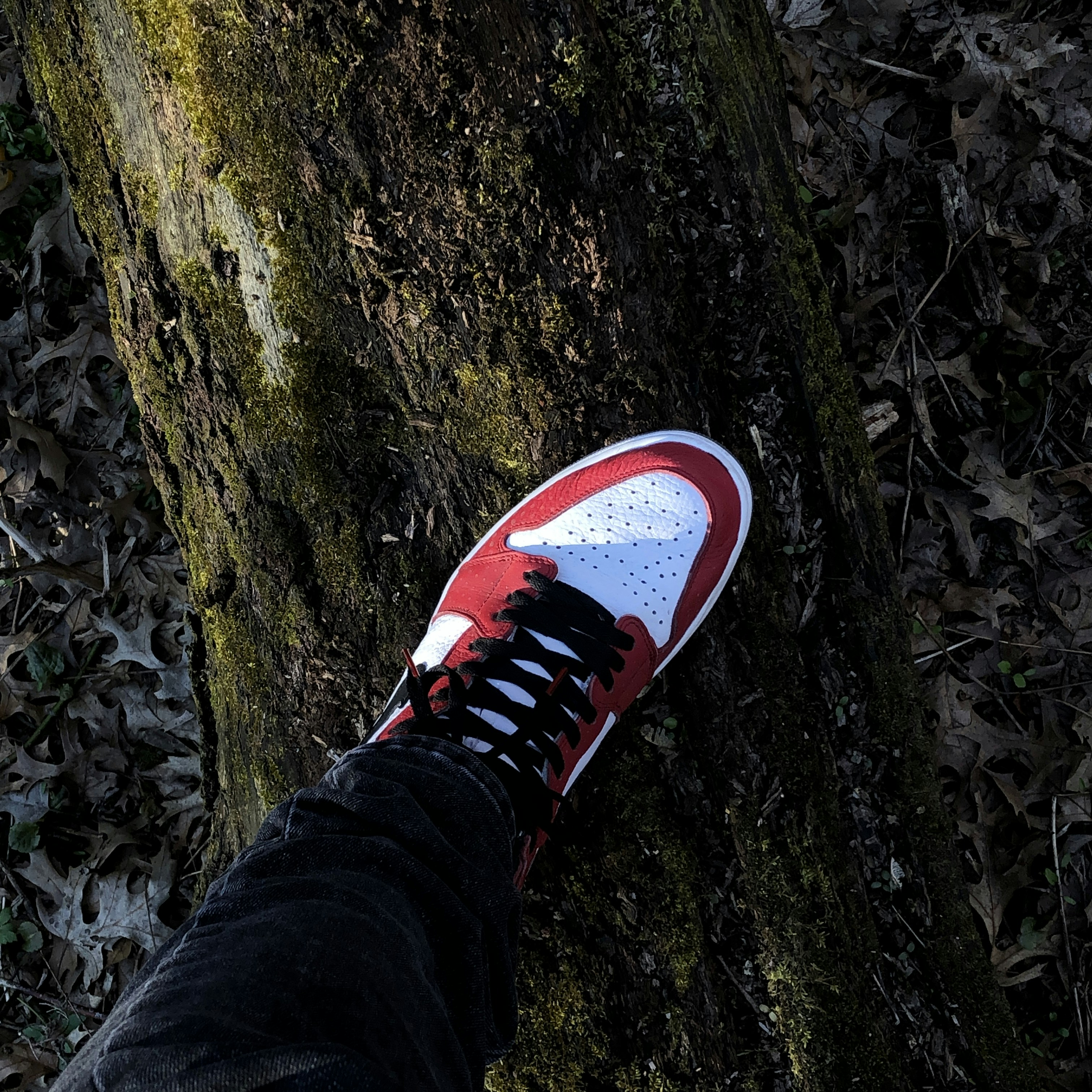 person wearing black and white nike sneakers