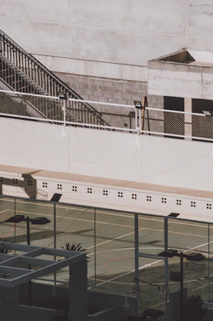 Close-up of premium court lighting and fencing installed around a multi-sport court.