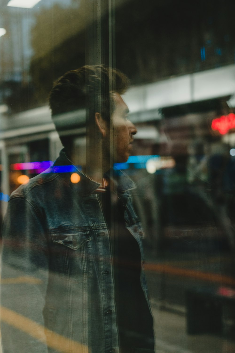 a man standing in front of a glass window