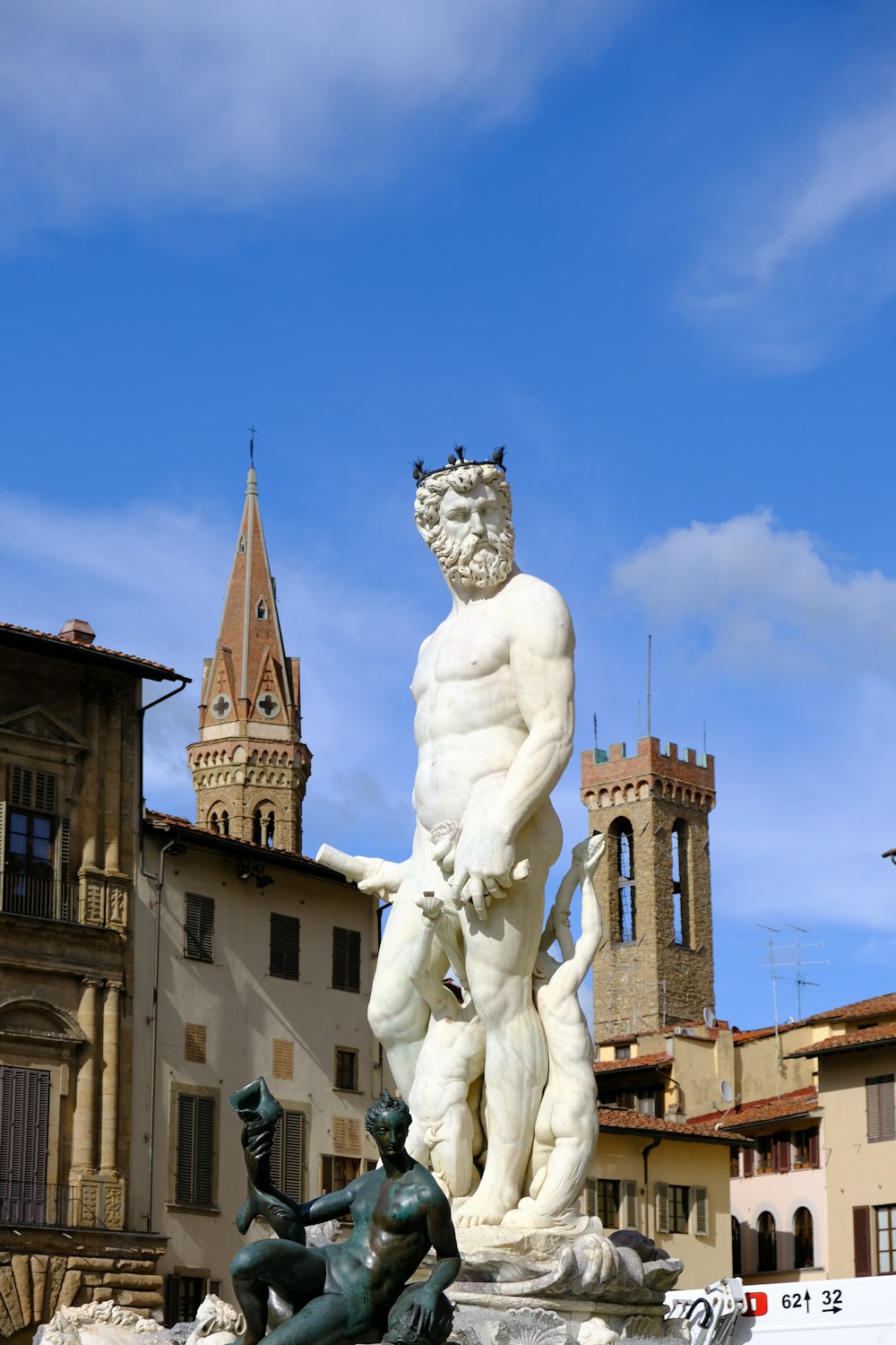 white concrete statue near brown concrete building during daytime