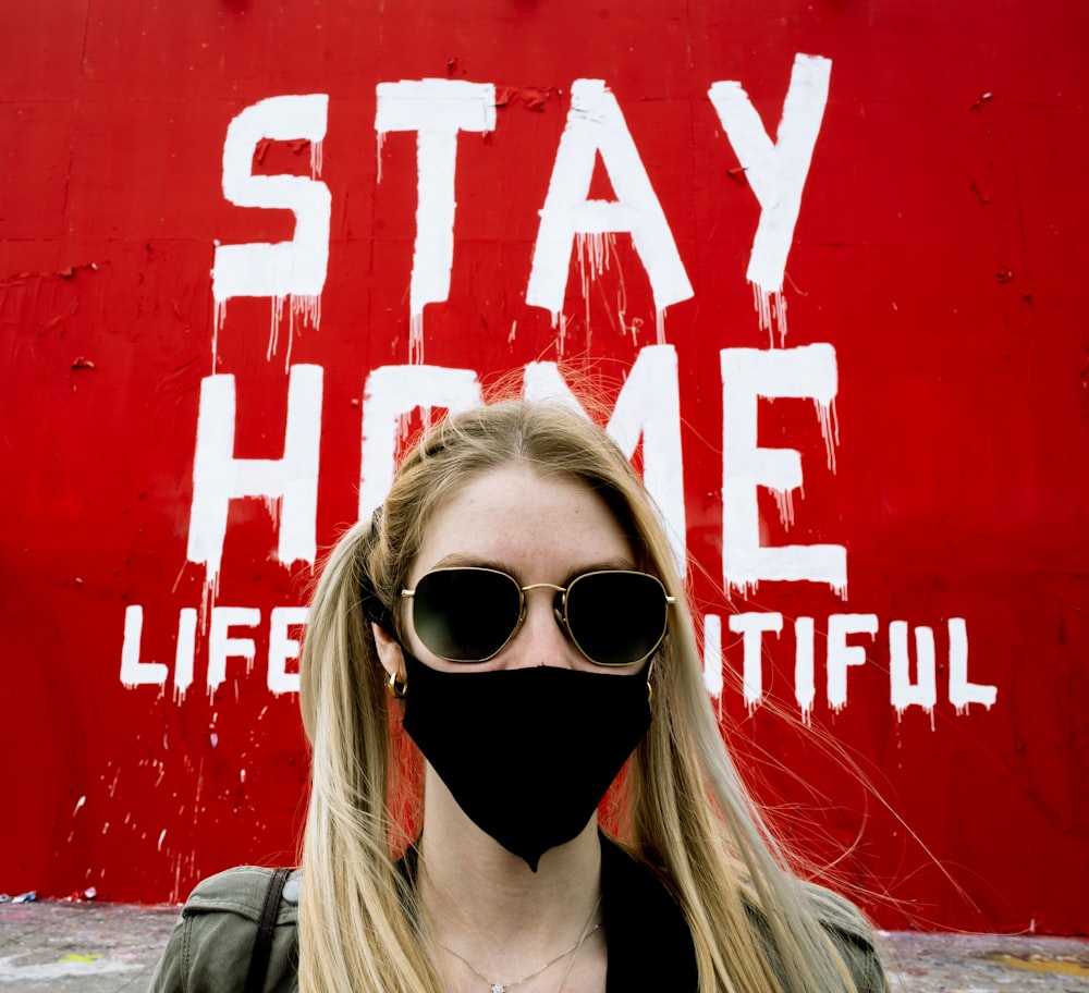 woman in black sunglasses and black jacket