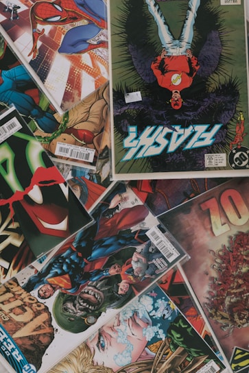 Colorful comic book pages spread out with dynamic superhero illustrations.