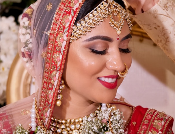 woman in red and gold floral hijab