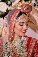 woman in red and gold floral hijab