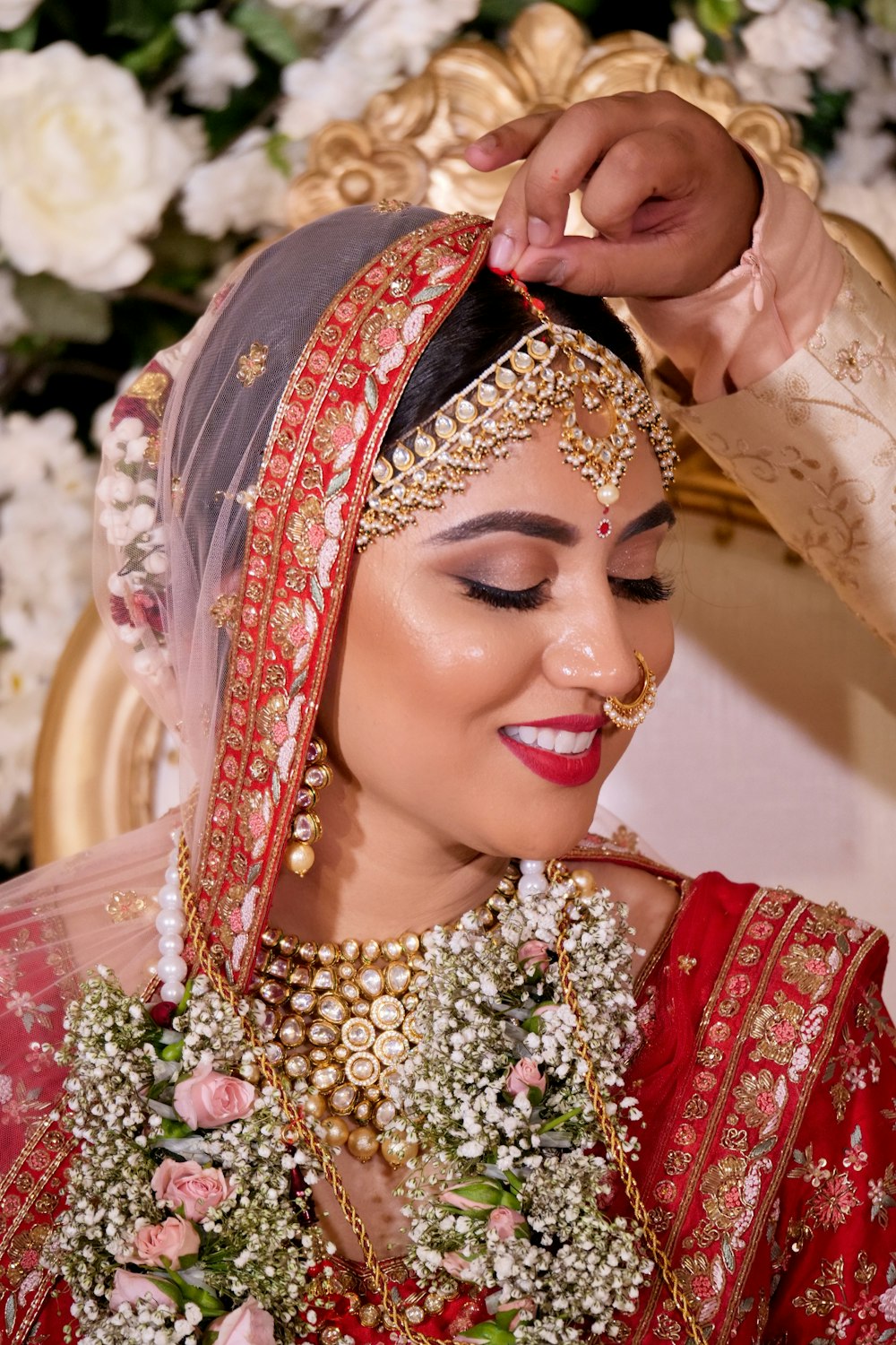 woman in red and gold floral hijab