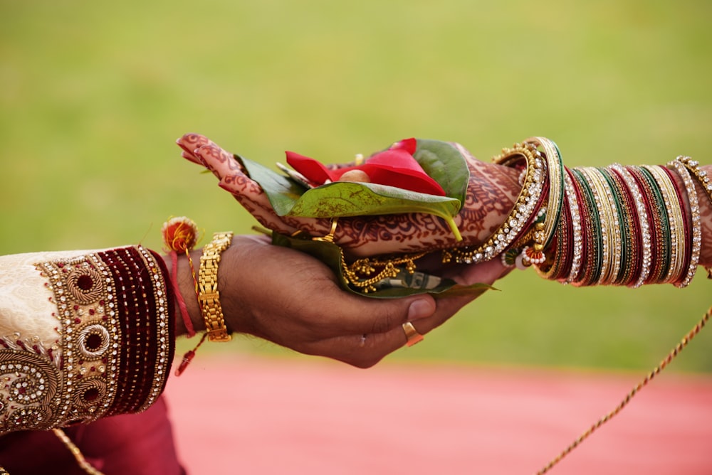 person holding bouquet of red roses