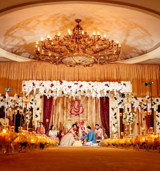 people standing in gold and white floral ceiling