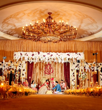 people standing in gold and white floral ceiling