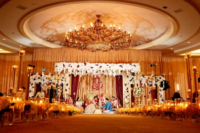 people standing in gold and white floral ceiling